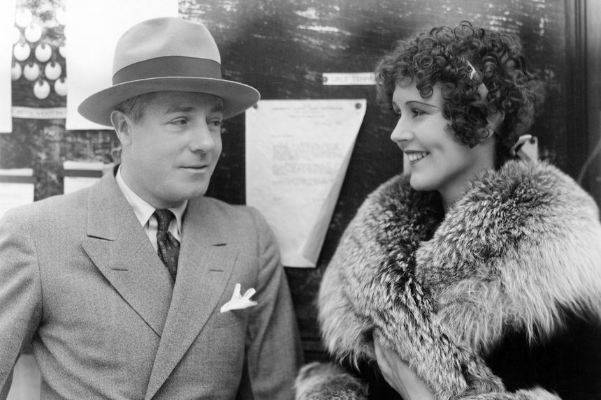 Woman in a fur coat having a conversation with a man