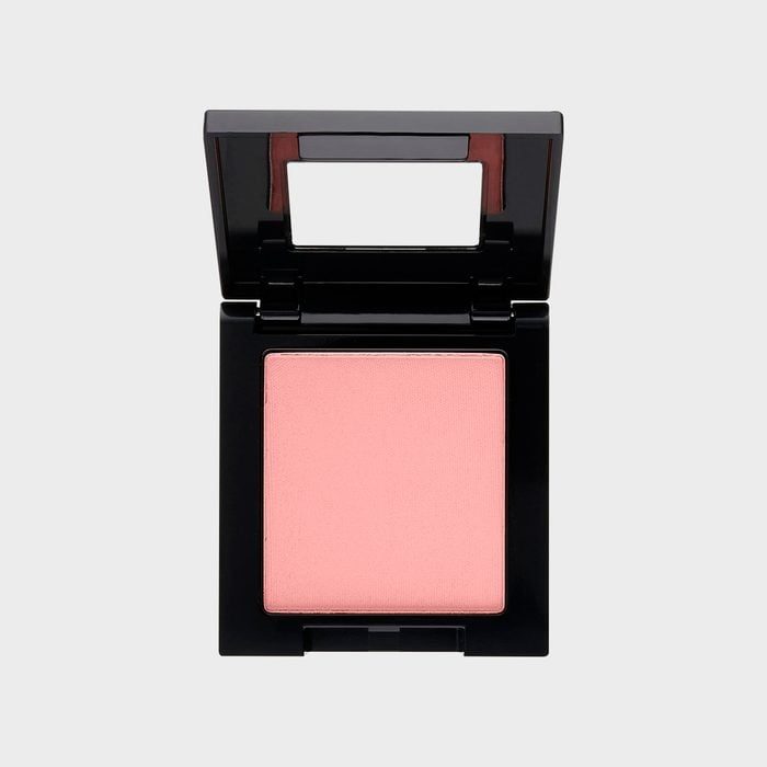 Compact blush sits open, displaying a soft pink color, housed in a square black case with a visible small mirror inside the lid.