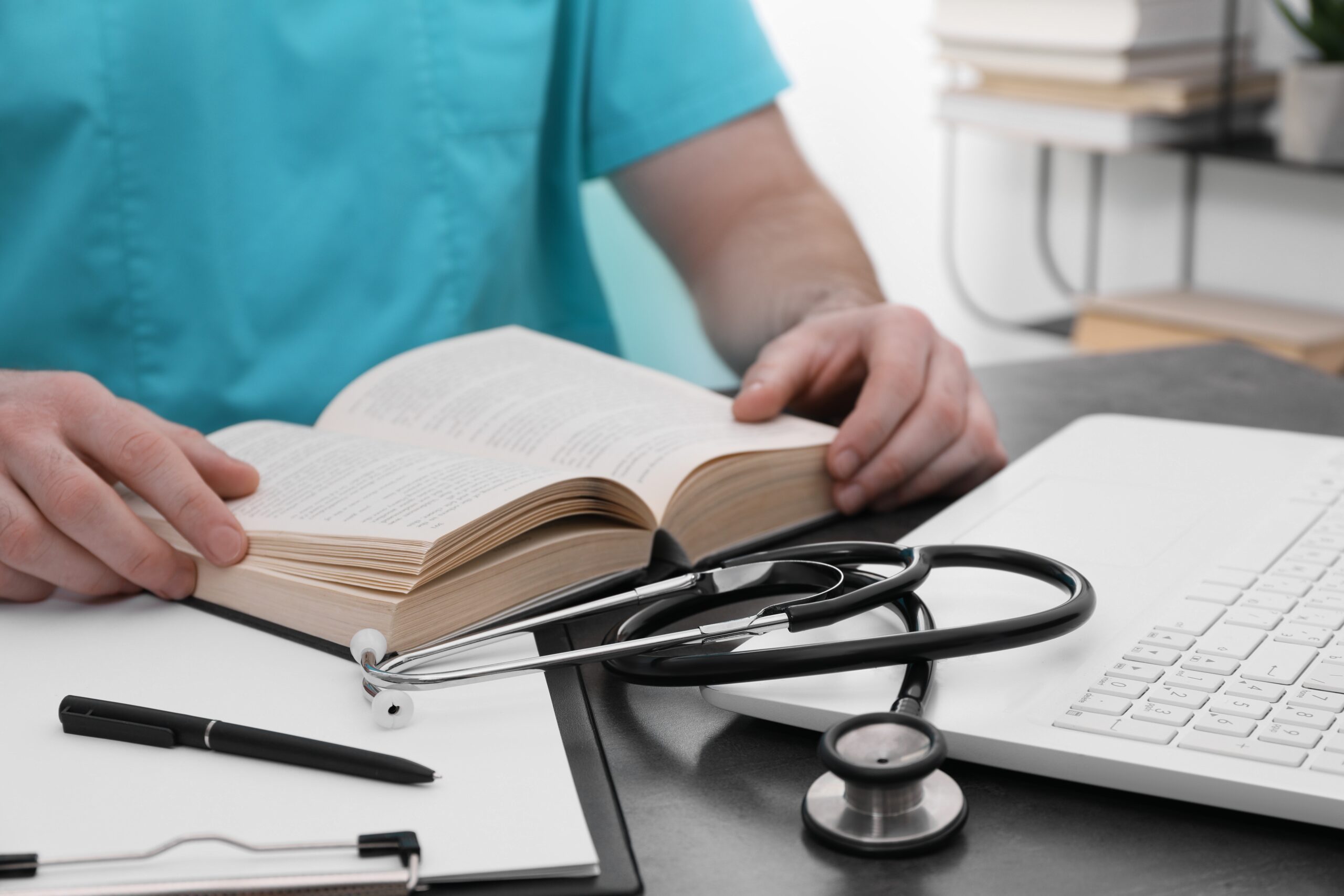 Medical,student,in,uniform,studying,at,table,indoors,,closeup