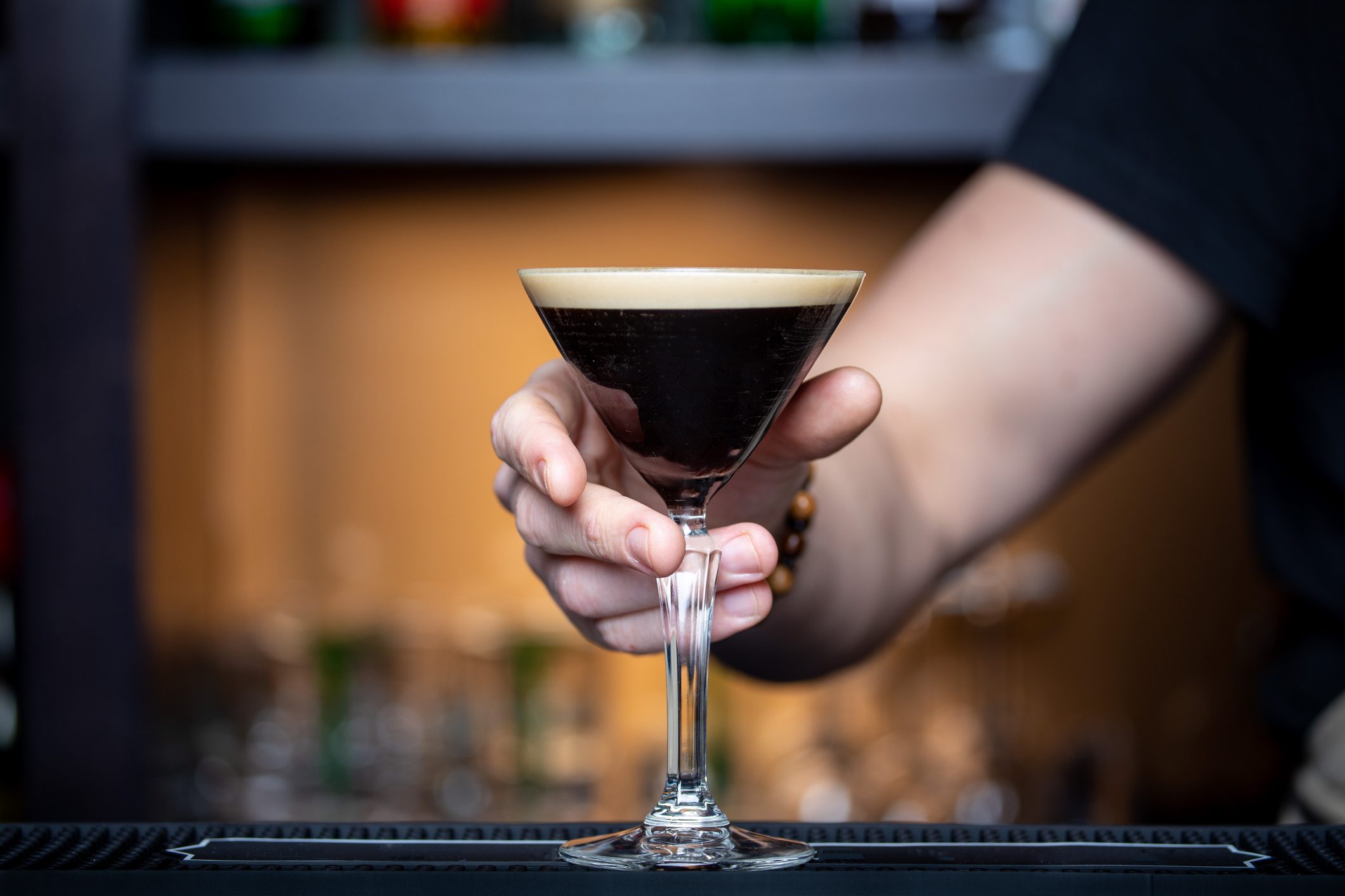 Midsection of woman holding an espresso martini