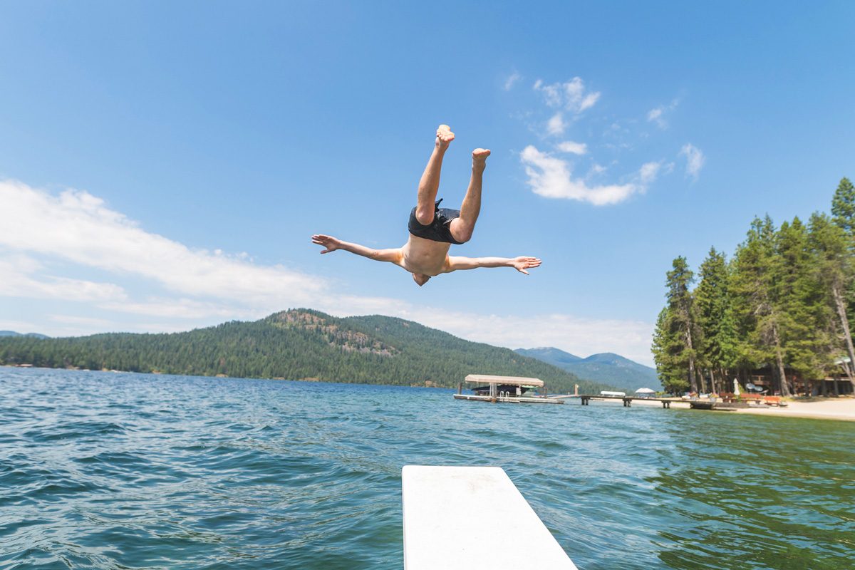 man diving into lake