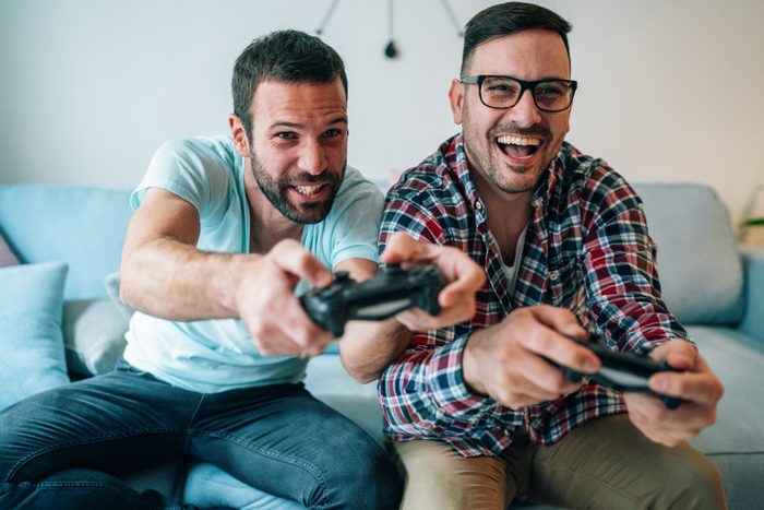 Excited friends playing video games