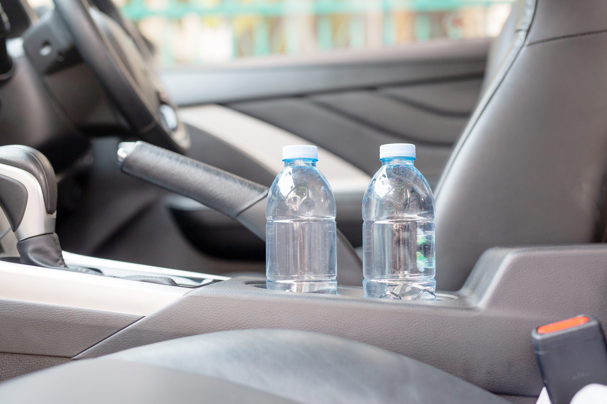 Drinking water in the car prepared for traveling