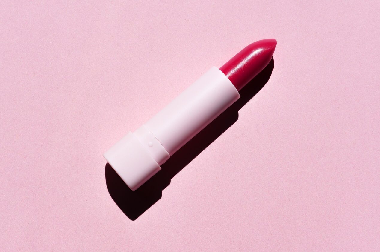 Red Lipstick Isolated on Pink Background