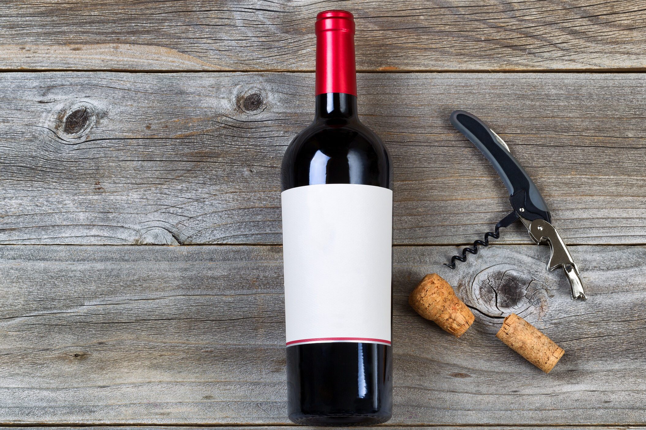 Red wine with Opener on Rustic wood