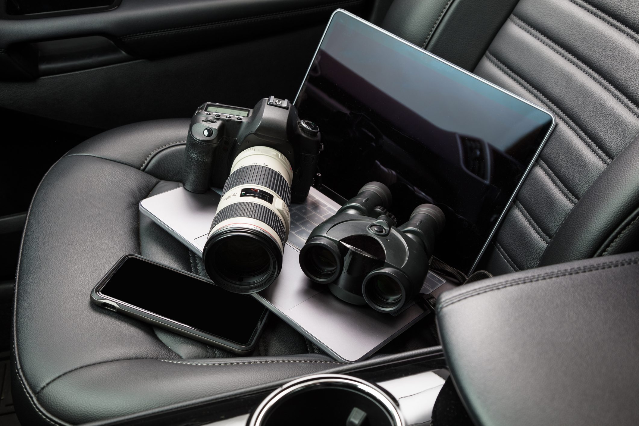 Private investigator tools on car seat